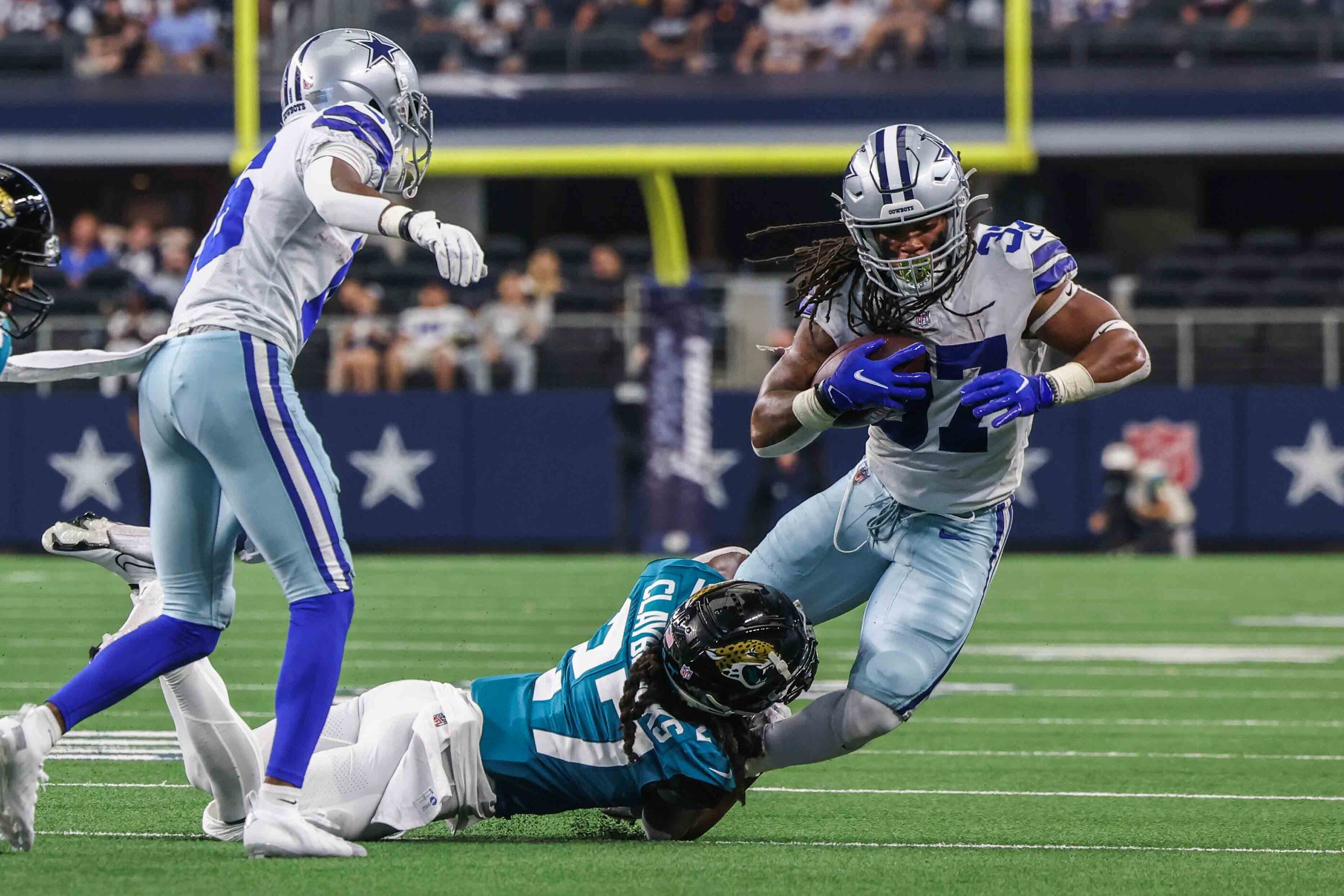 Dallas Cowboys' offense JaQuan Hardy, 37, trips over Jacksonville Jaguars' Chris Claybrooks,...