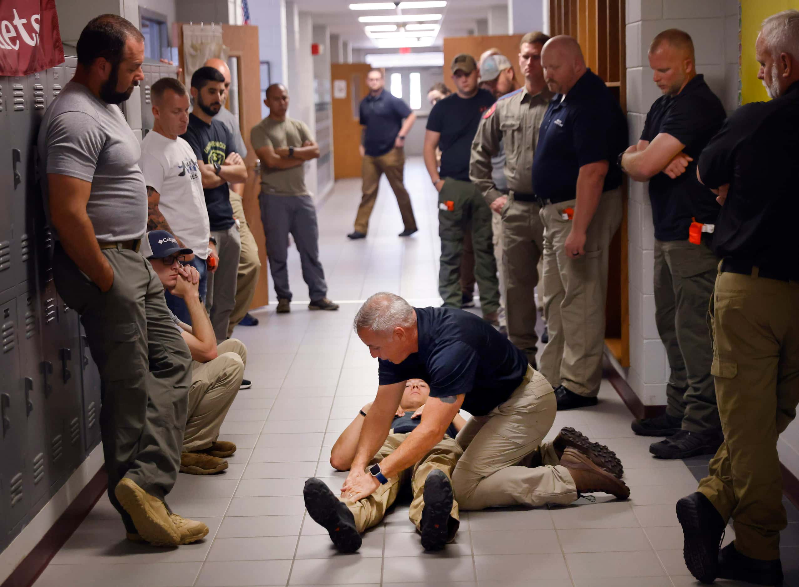 Advanced Law Enforcement Rapid Response Training instructor Troy Dupuy (left) shows how to...