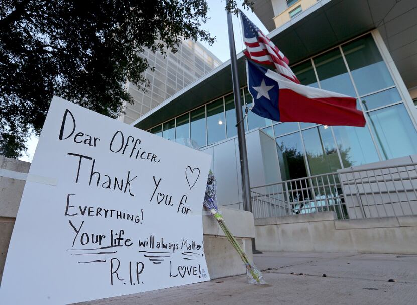 An American flag and Texas state flag flew at half-staff Sunday at San Antonio Police...