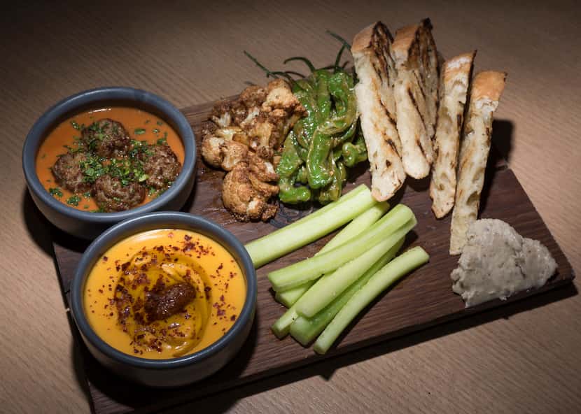 The meze is a board of treats that includes lamb-sausage meatballs, sweet potato puree,...