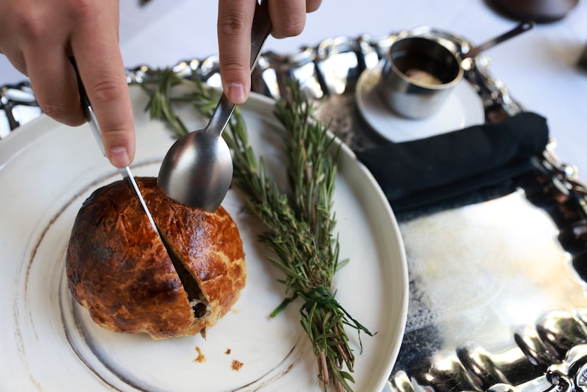 Chef Ji Kang cuts beef Wellington at Dakota's Steakhouse in Dallas.