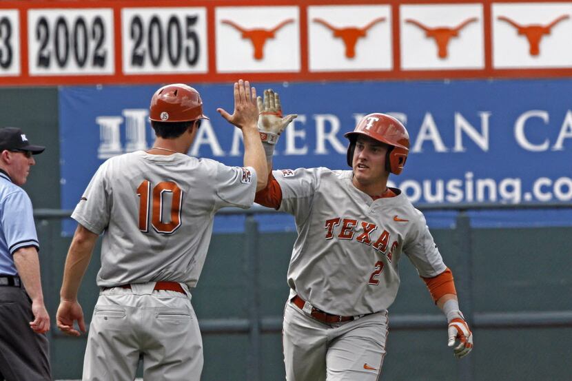 Texas's Mark Payton (2) celebrates after hitting a home run against Houston in the first...