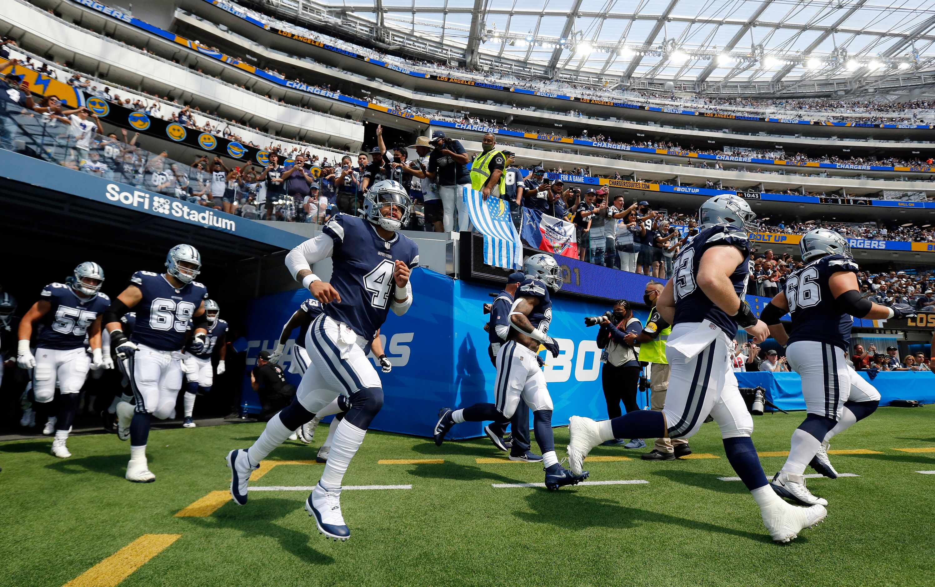 Dallas Cowboys quarterback Dak Prescott (4) races onto the field with teammates to face the...