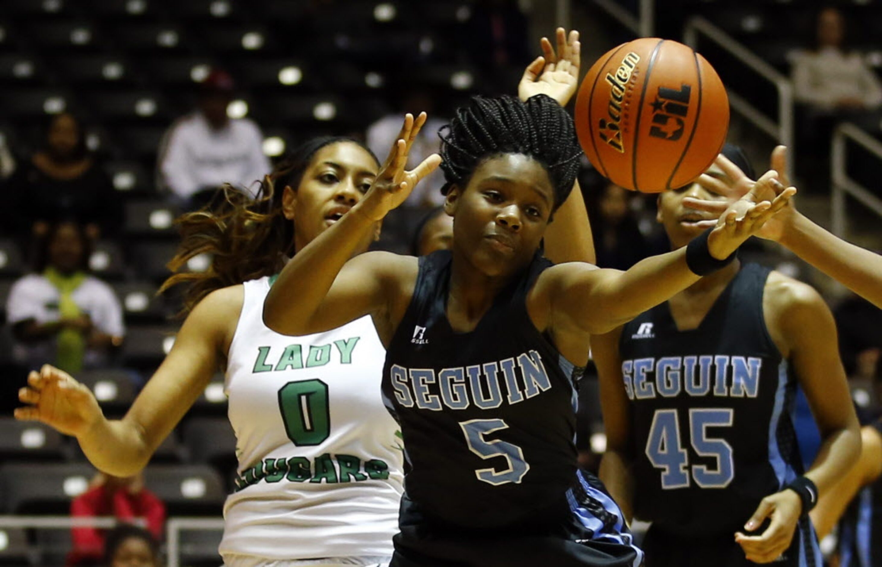 Arlington Seguin's Lisa Taylor (5) reaches for the loose ball as Bryan Adams' Jerice Fears...