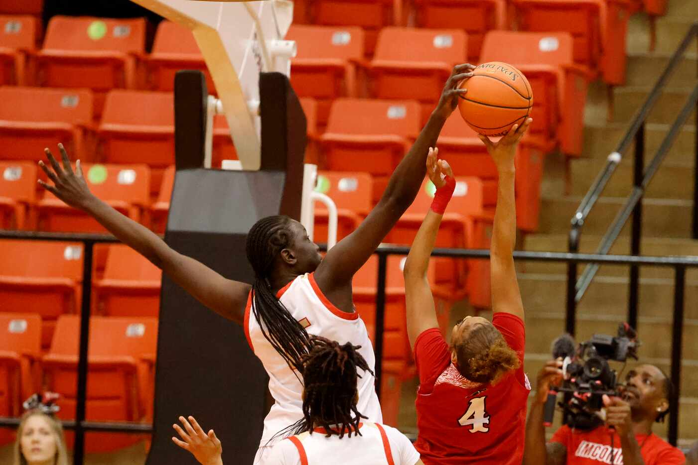 South Grand Prairie’s Adhel Tac (#15) blocks a shot by Denton Braswell’s Kennedy Evans (#4)...