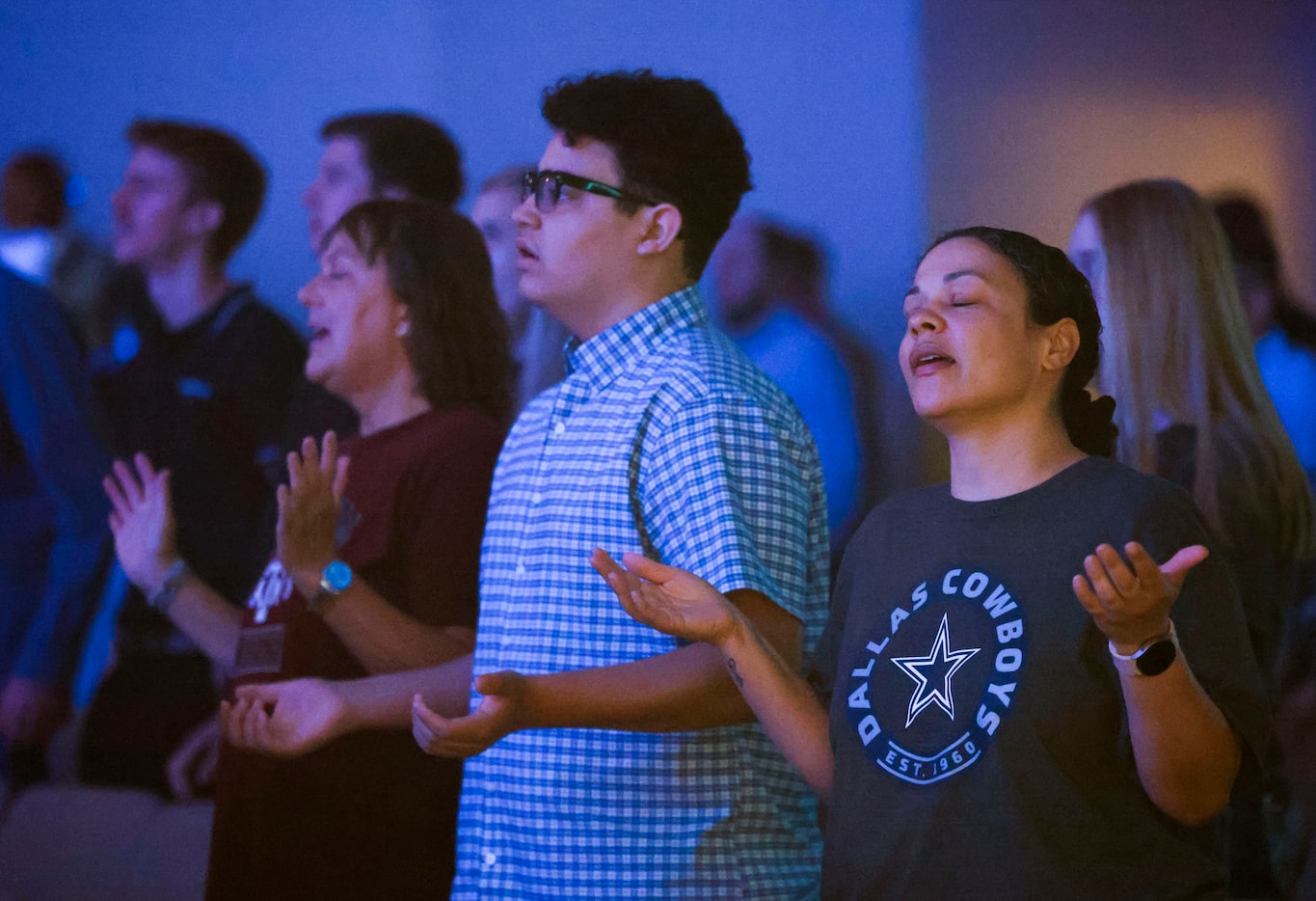 Tara Perry (right) prays alongside her son Devin, (center), 14, and mother Kandy during a...