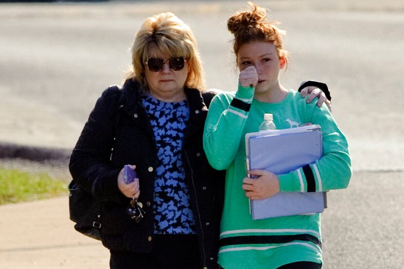 A student and guardian walk to their car from Franklin Regional Middle School after 19...