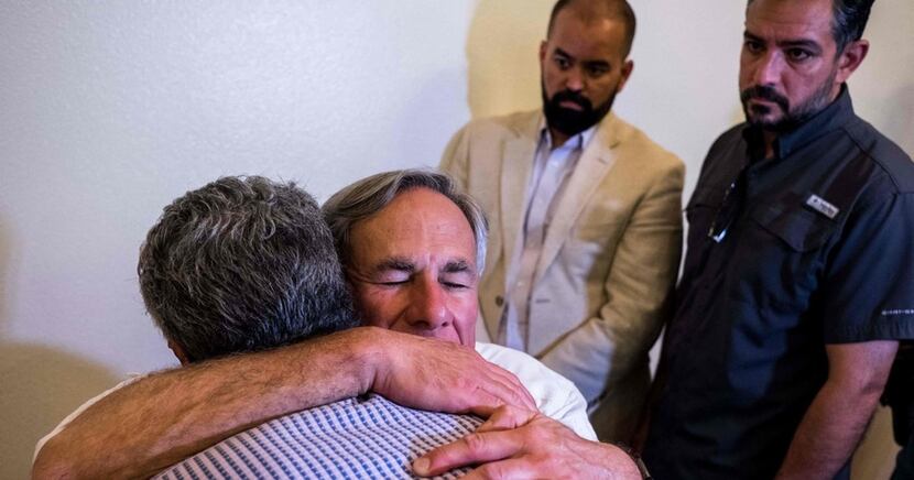 Gov. Greg Abbott, shown hugging an El Paso resident after a vigil at a Catholic church there...