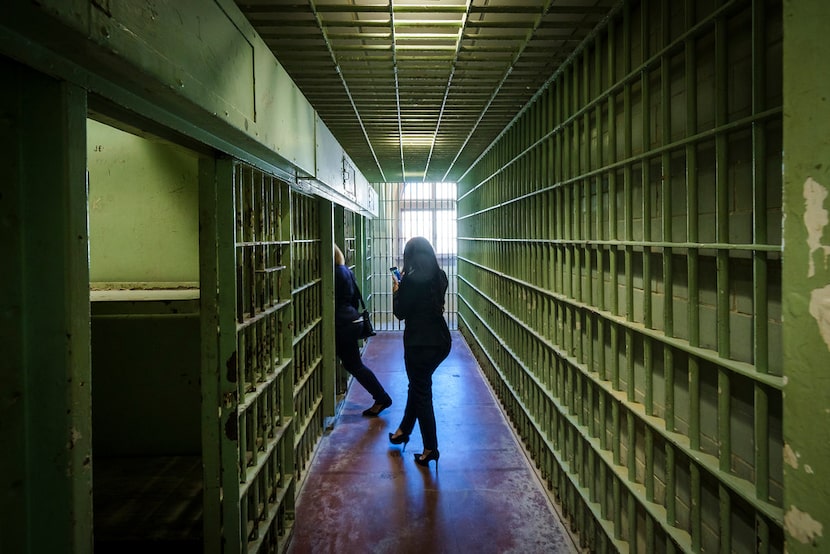 Ceremony guests tour the jail cells where Lee Harvey Oswald was held are seen following a...