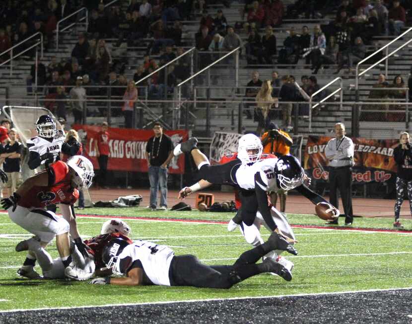 Wylie quarterback Emilio Ames (15) leaped for the end zone Oct. 29. In an upset at Lovejoy...