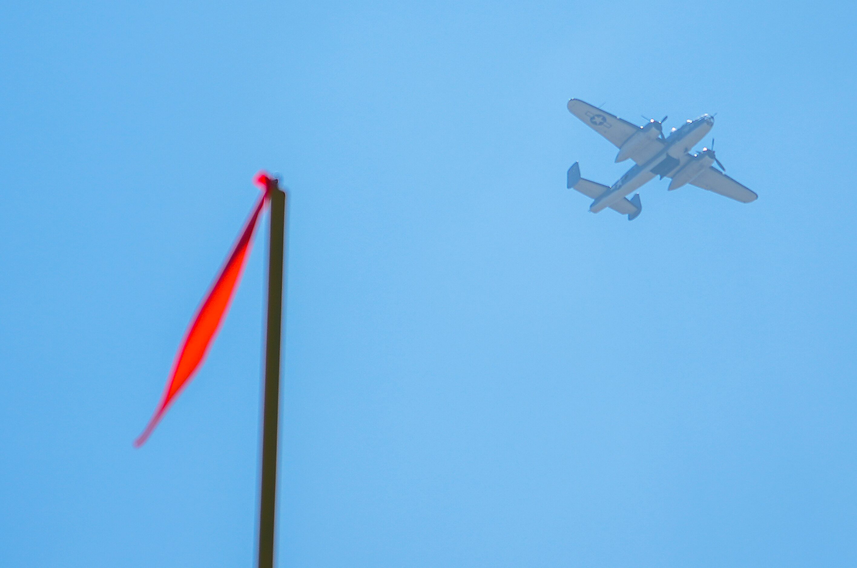 A vintage military aircraft flies over the complex during a training camp practice on...