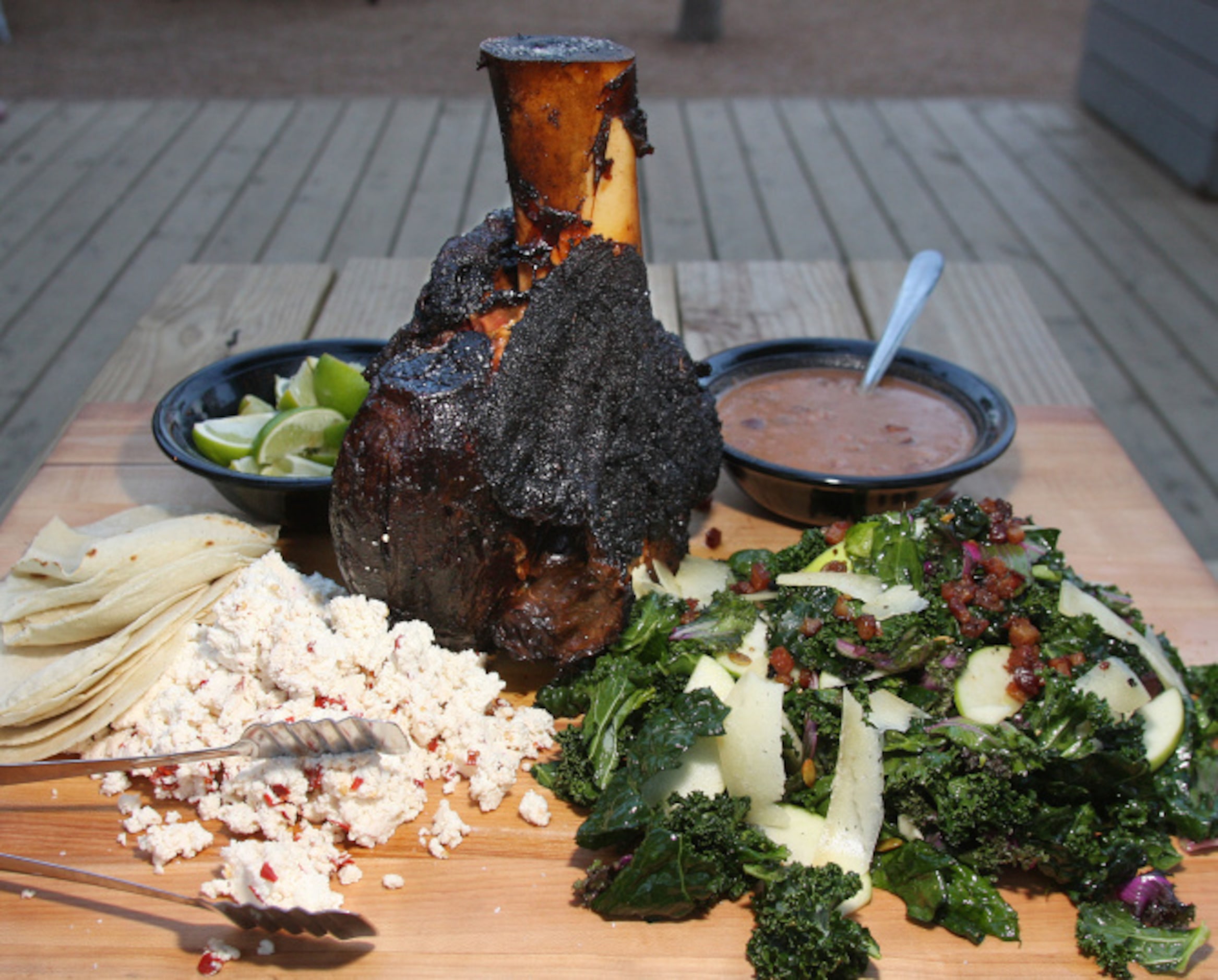 WOODSHED SMOKEHOUSE: A 16-hour smoked beef shin, served with fresh ricotta, borracho beans...