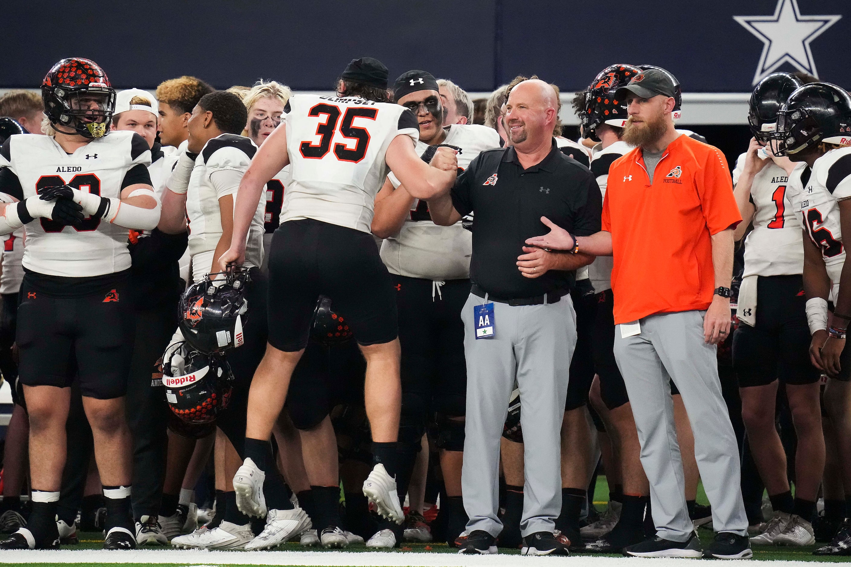 Aledo head coach Robby Jones celebrates with defensive lineman Carson Dempsey (35) as time...