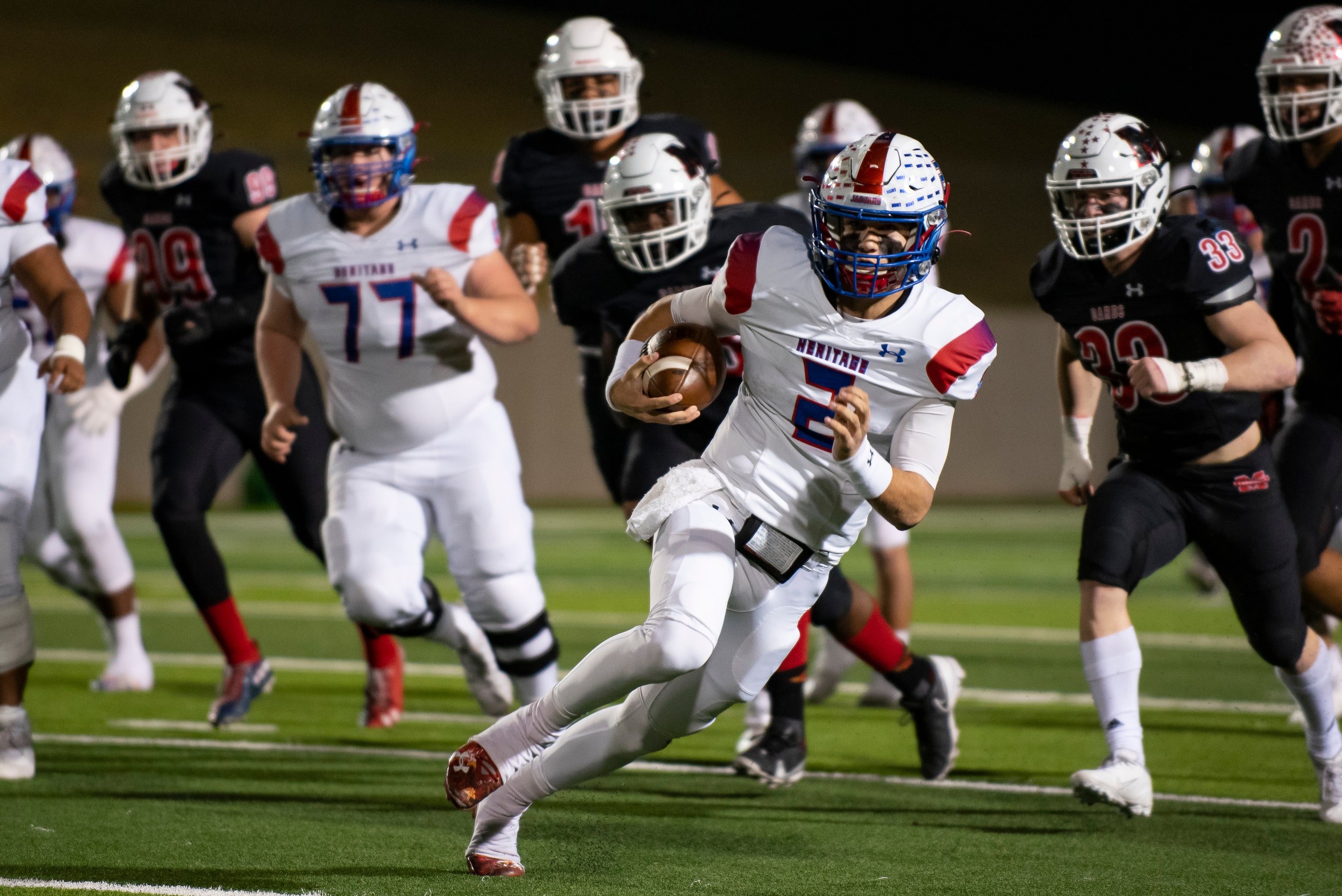 Midlothian Heritage junior Kaden Brown (2) looks to avoid a tackle after getting a first...