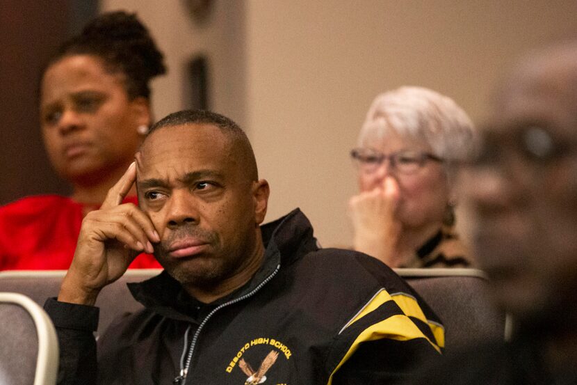 Russell Hooper (center) listens with other attendees at a special town hall presentation of...