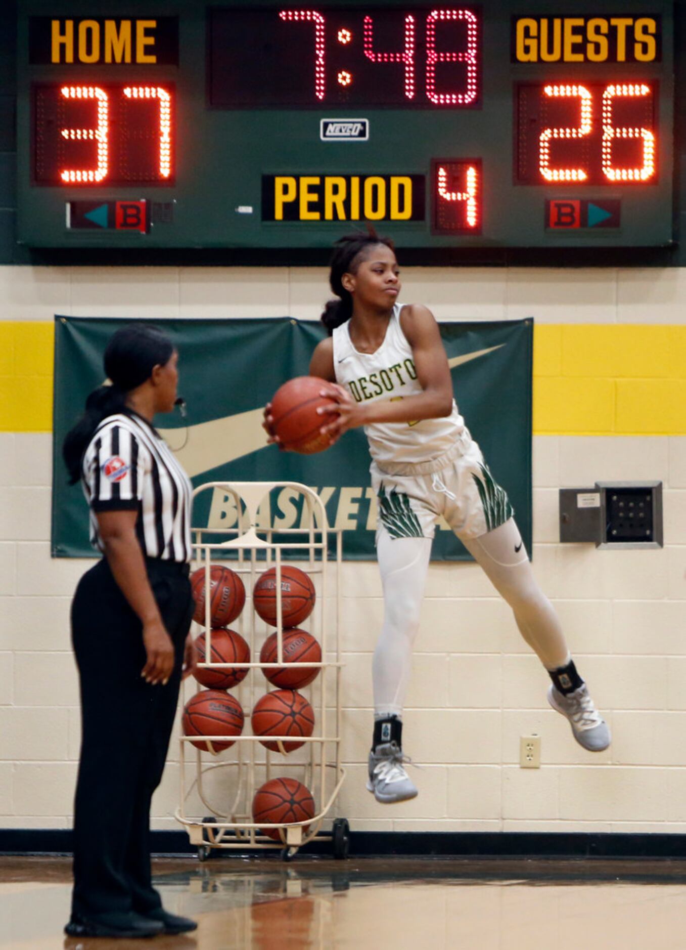 DeSoto's Ja'Mia Harris (4) leaps to keep the ball in bounds during 4th quarter action...
