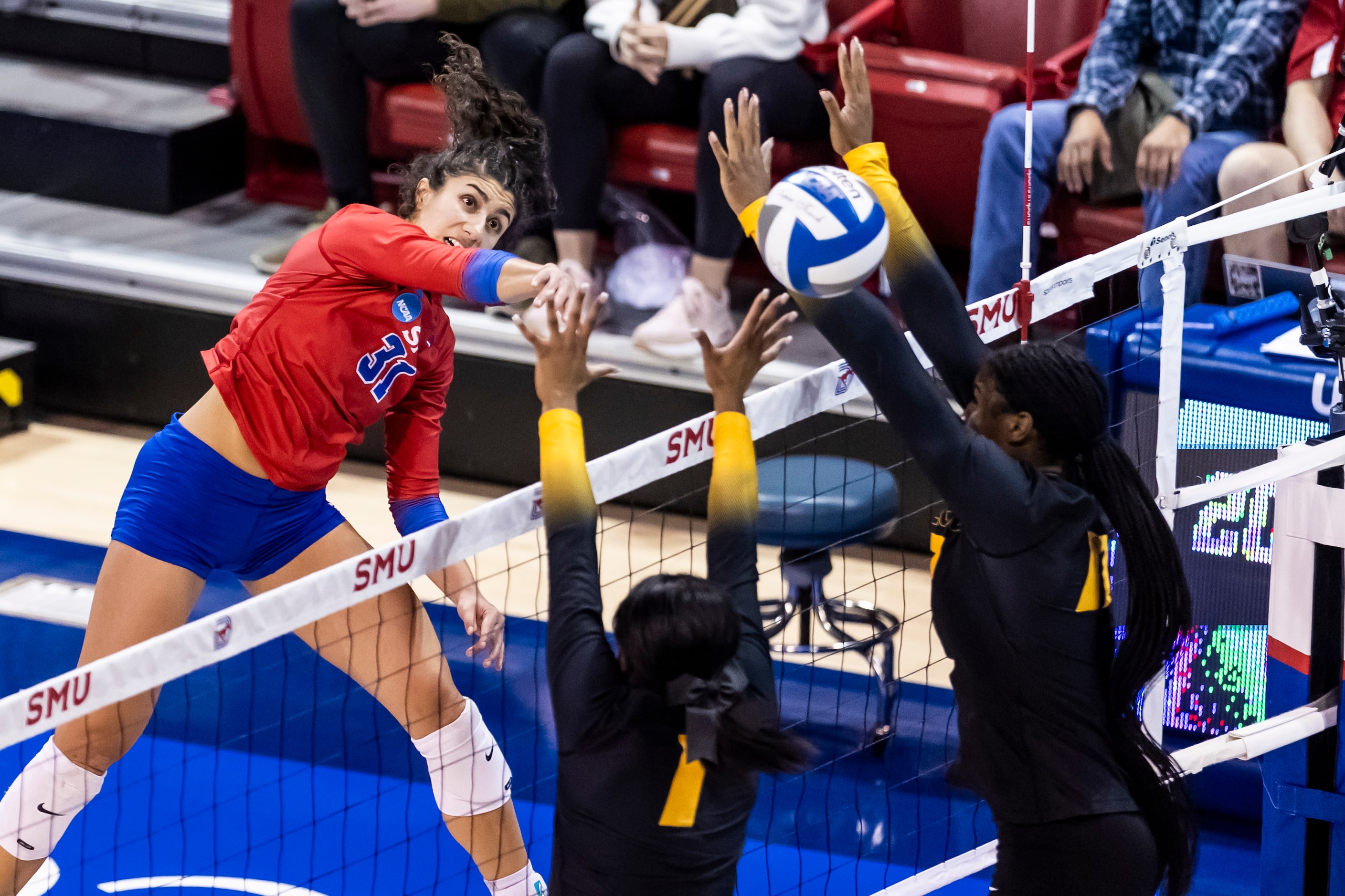 SMU’s Maya Tabron (31) spikes the ball as Missouri’s Colleen Finney (1) and Naomi Franco...