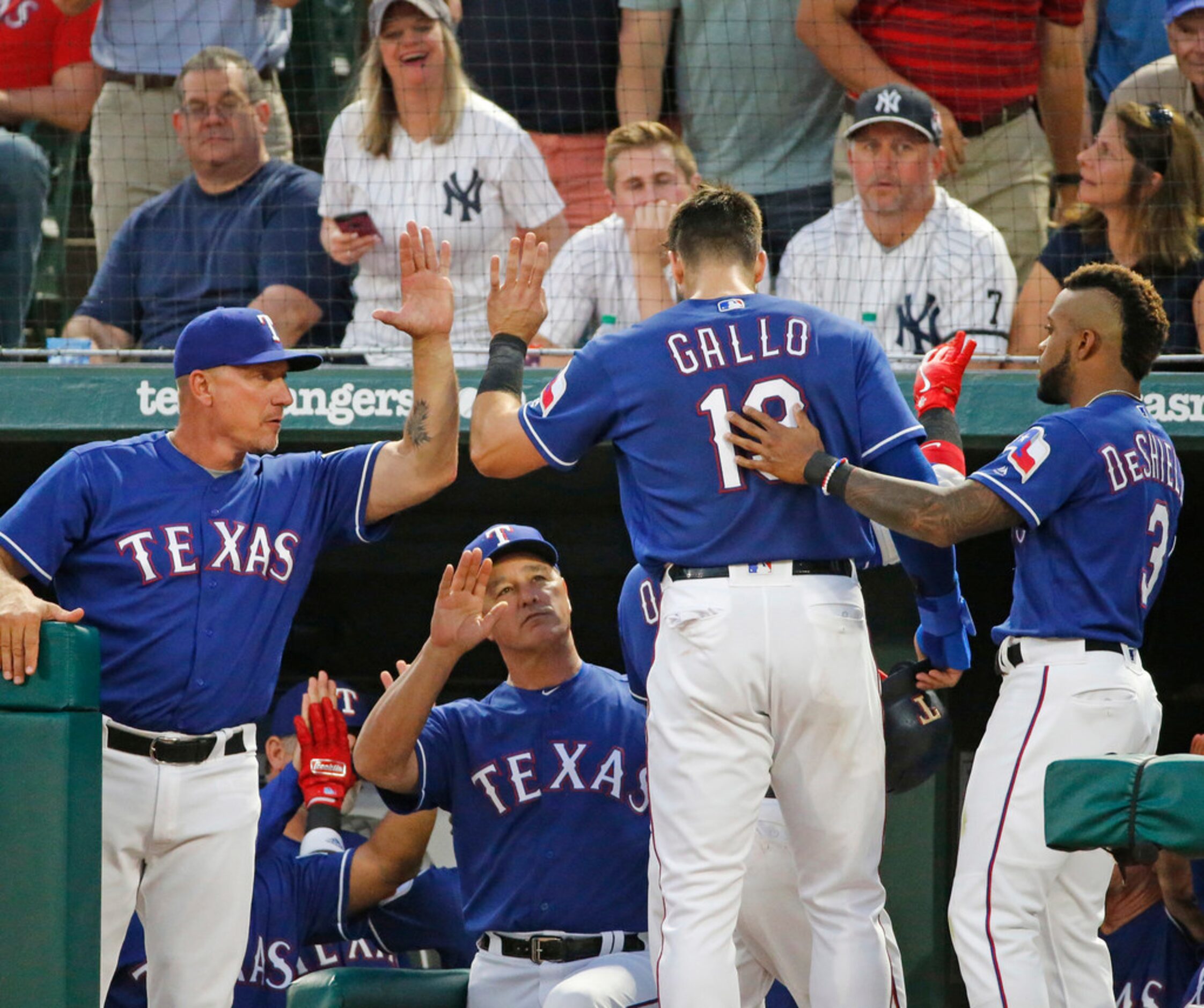 Texas Rangers manager Jeff Banister (28) congratulates Texas Rangers left fielder Joey Gallo...