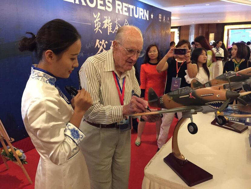 
Leroy Parramore signs a model airplane during a trip in September to China to celebrate the...