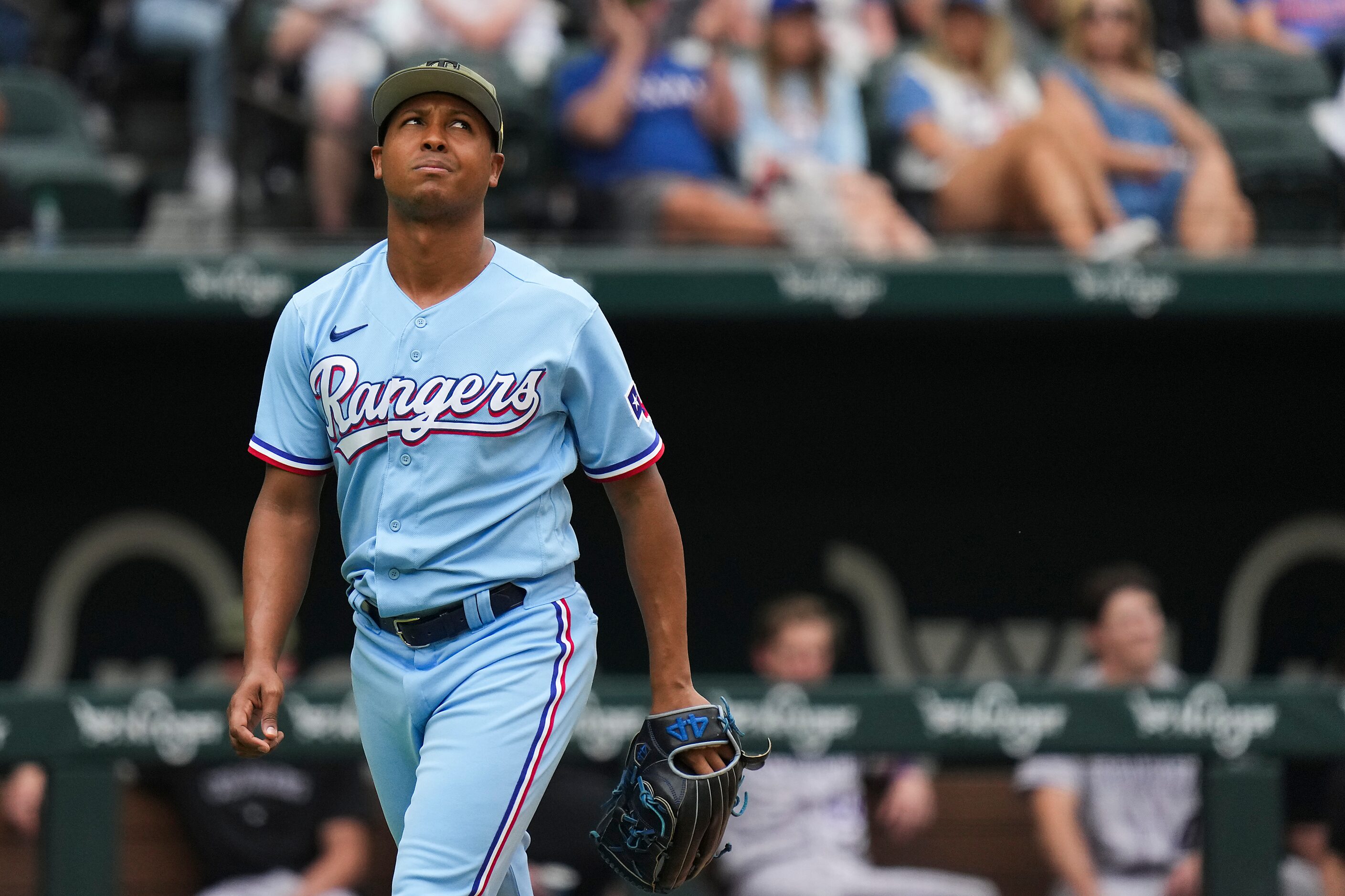 Texas Rangers relief pitcher Jose Leclerc looks up after giving up two runs during the...