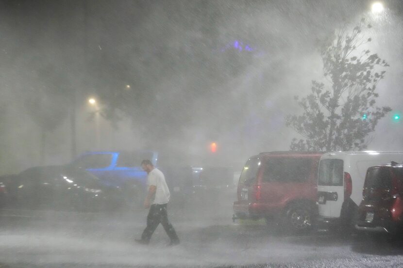 Max Watts, of Buford, Ga., walks in the parking lot to check on a trailer parked outside the...