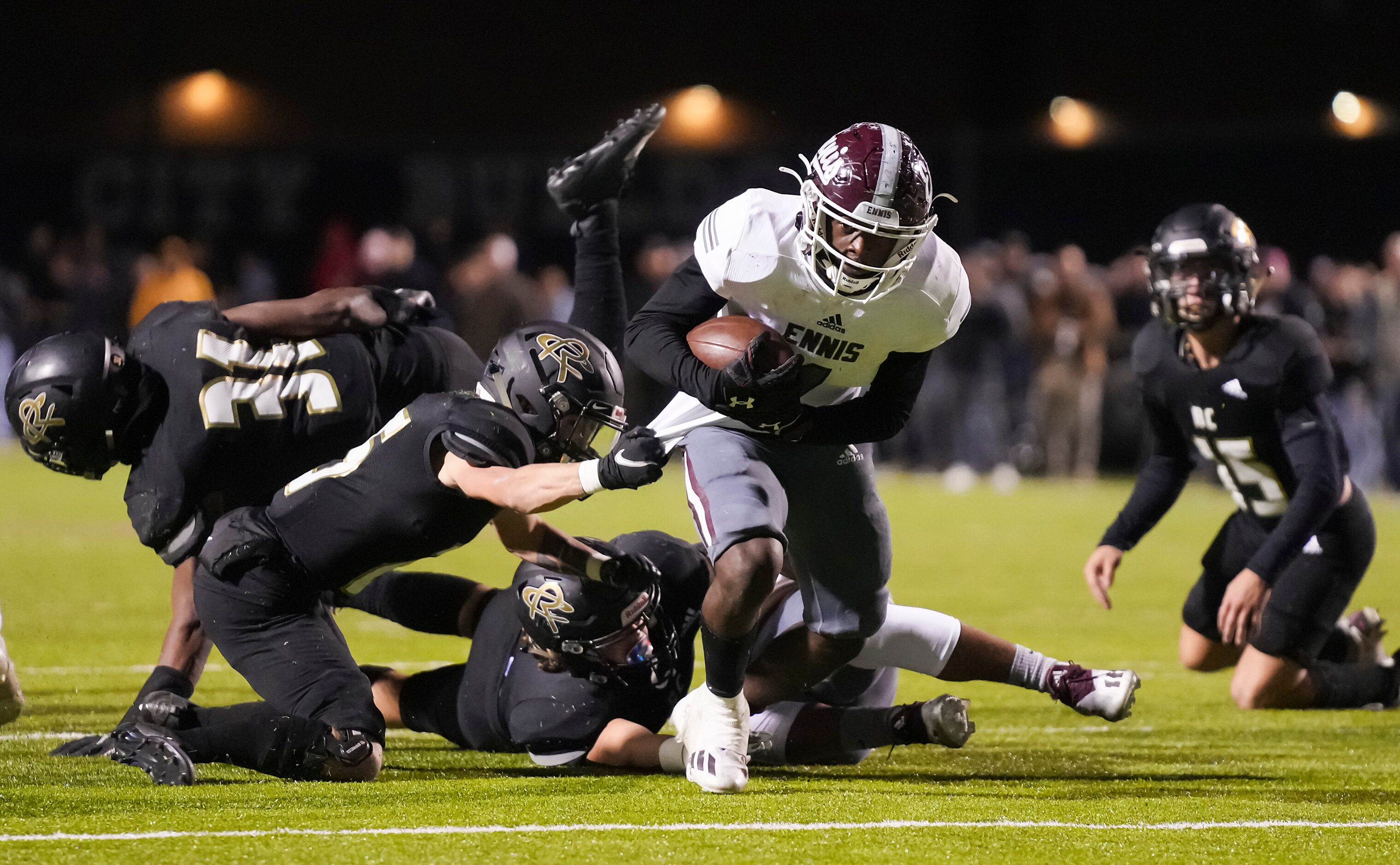 Ennis running back Devion Beasley (1) gets past Royse City defensive back Hayden Adams (25)...