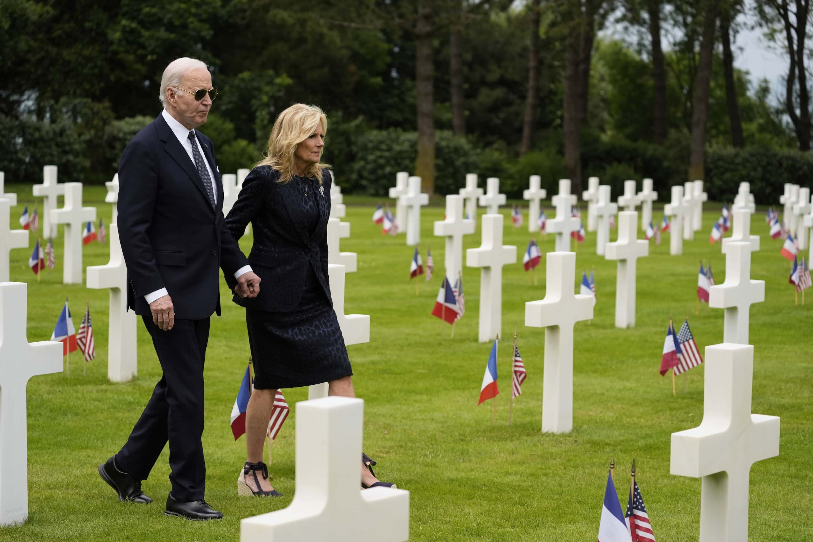 President Joe Biden and first lady Jill Biden walk in the Normandy American Cemetery...