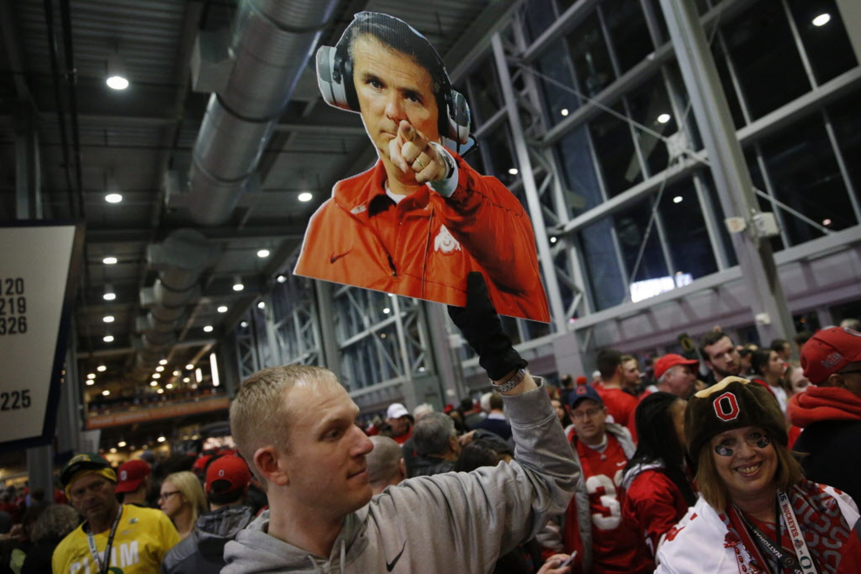 Ohio State Buckeyes fan Dave Sunderman, of Cleveland, Ohio, displays a poster of Ohio State...