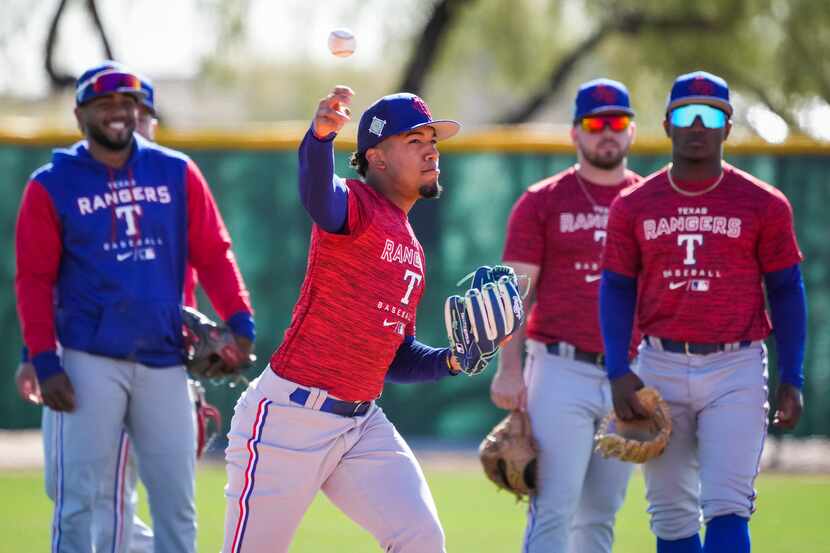 Infielder Maximo Acosta makes a throw during a Texas Rangers minor league spring camp...