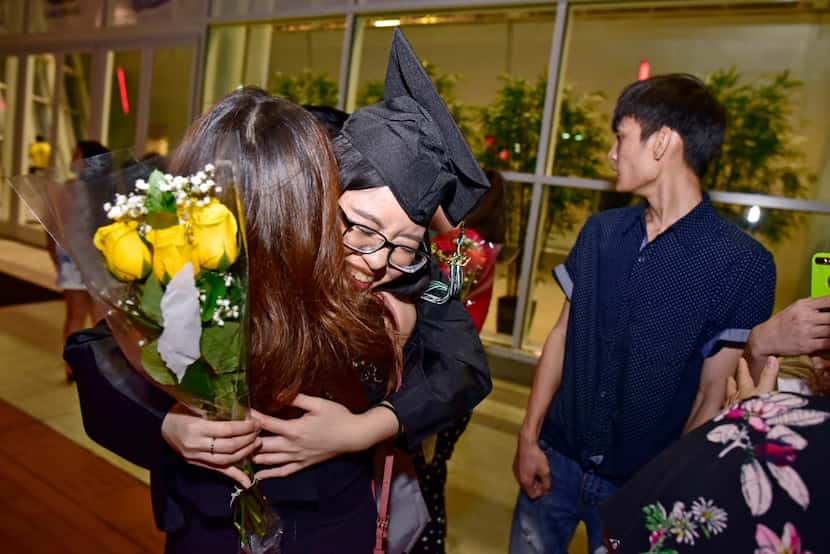 Valedictorian Tran Bao Tran is congratulated by a friend after she and her sisters graduated.