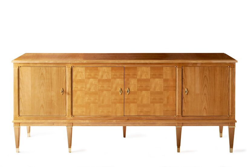 The Veronique Credenza's details include checkerboard veneer doorfronts and brass hardware...