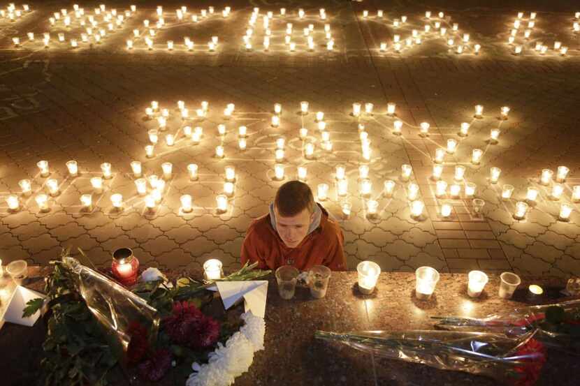 
Candles and flowers are left in Simferopol on the Crimean peninsula in memory of the...
