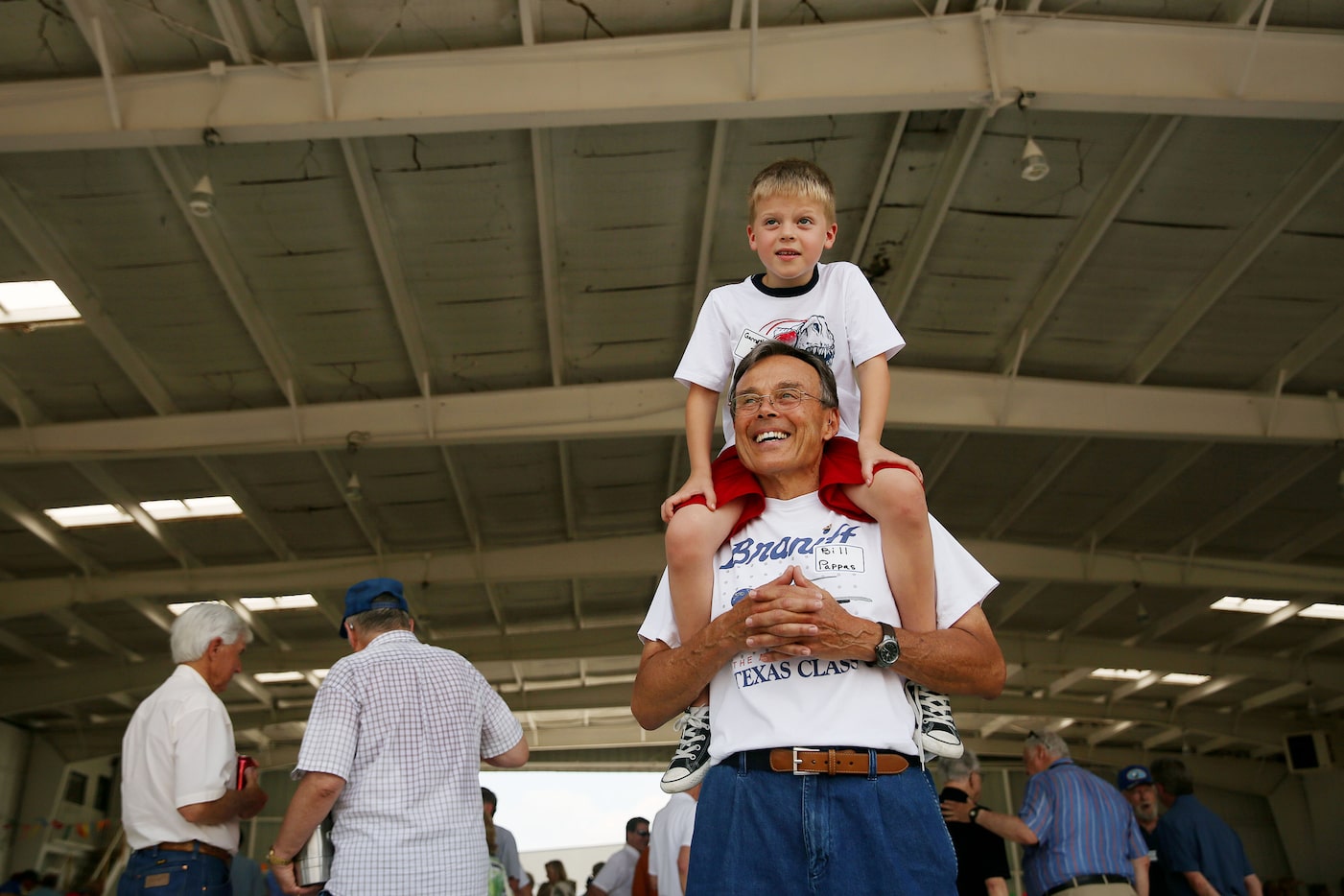 Bill Pappas, who was a pilot for Braniff for nine years, carries his grandson Garrett...