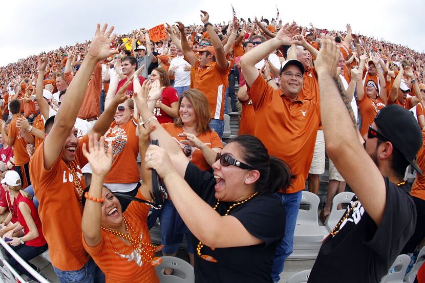 Texas Longhorns fan in the upper on course celebrate a first quarter fumble recovery against...
