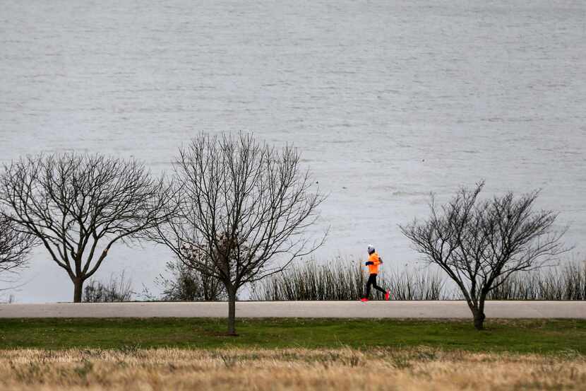 Susan Tiner ran in 24-degree weather at White Rock Lake in Dallas on Monday morning.