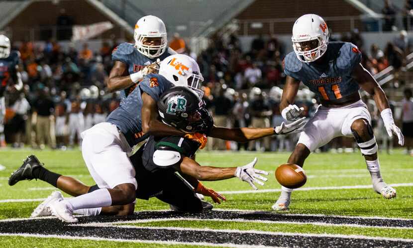 Lancaster defensive back Lorando Johnson (13) prevents a catch near the end zone by...