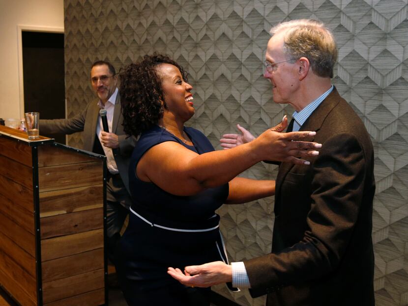 Leona Allen gives a hug to A. H. Belo Corp. CEO Robert Decherd after being announced as this...