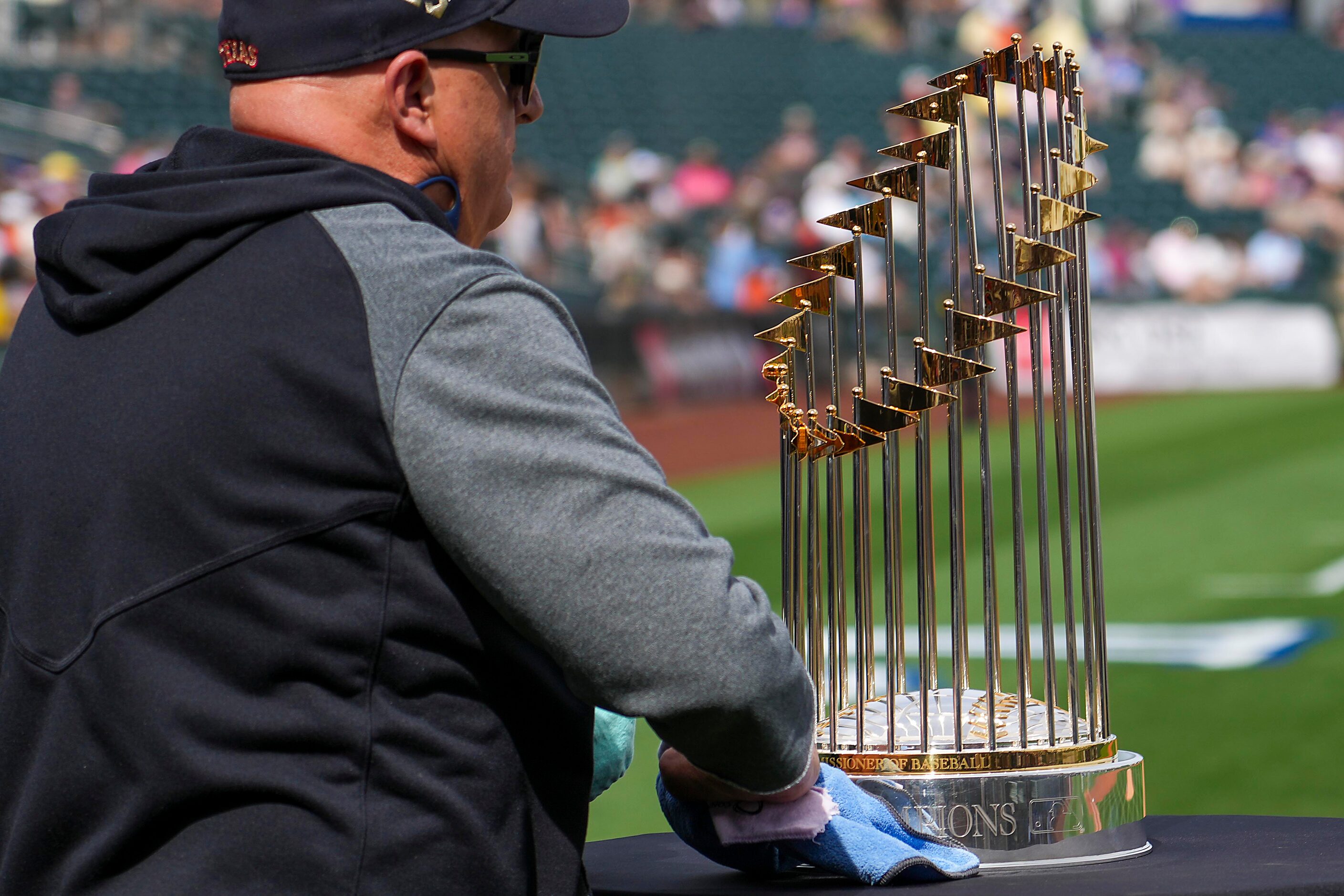 Blake Miller, the Texas Rangers' vice president of security, cleans the Commissioner’s...