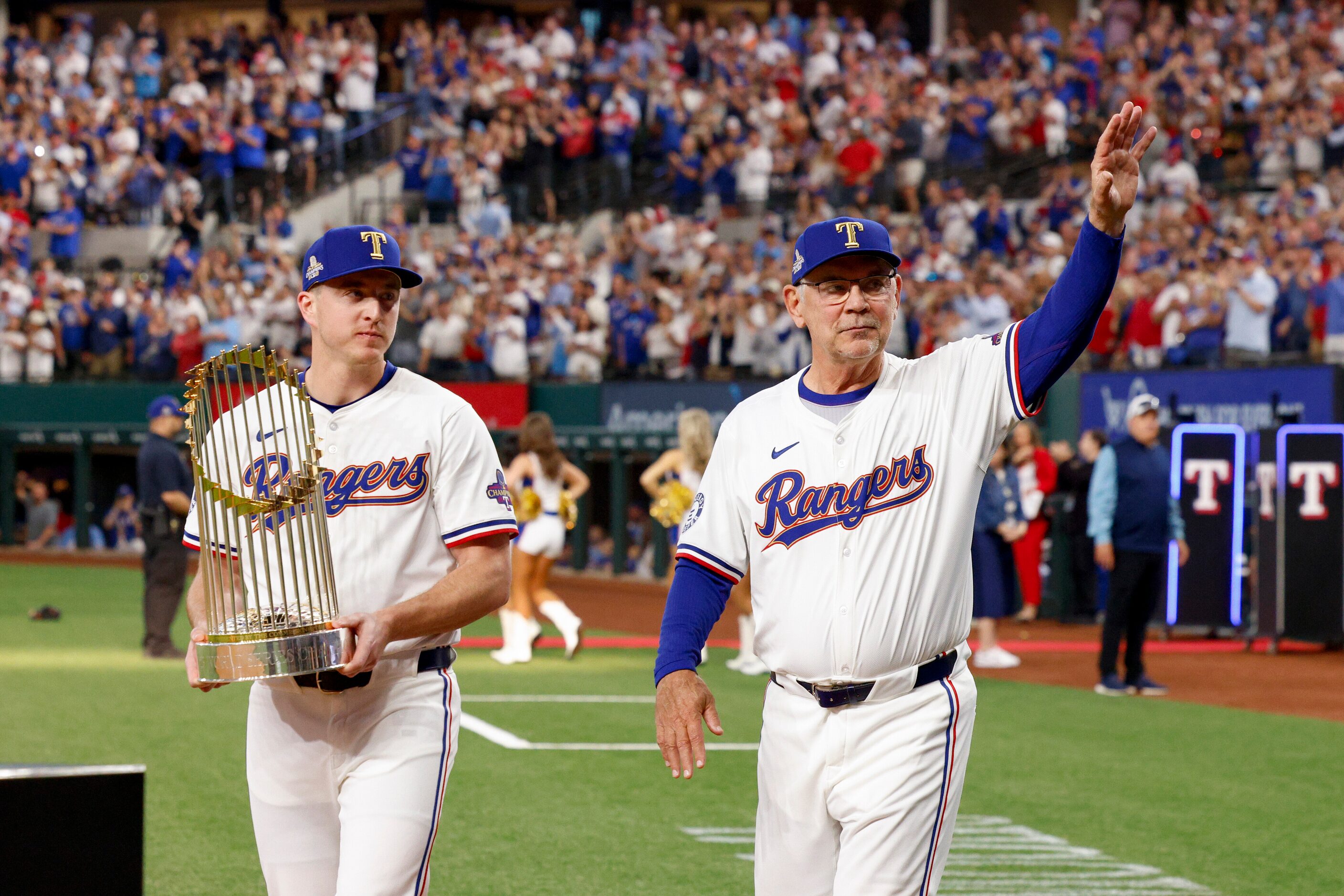 Texas Rangers relief pitcher Josh Sborz carries the World Series championship trophy as...