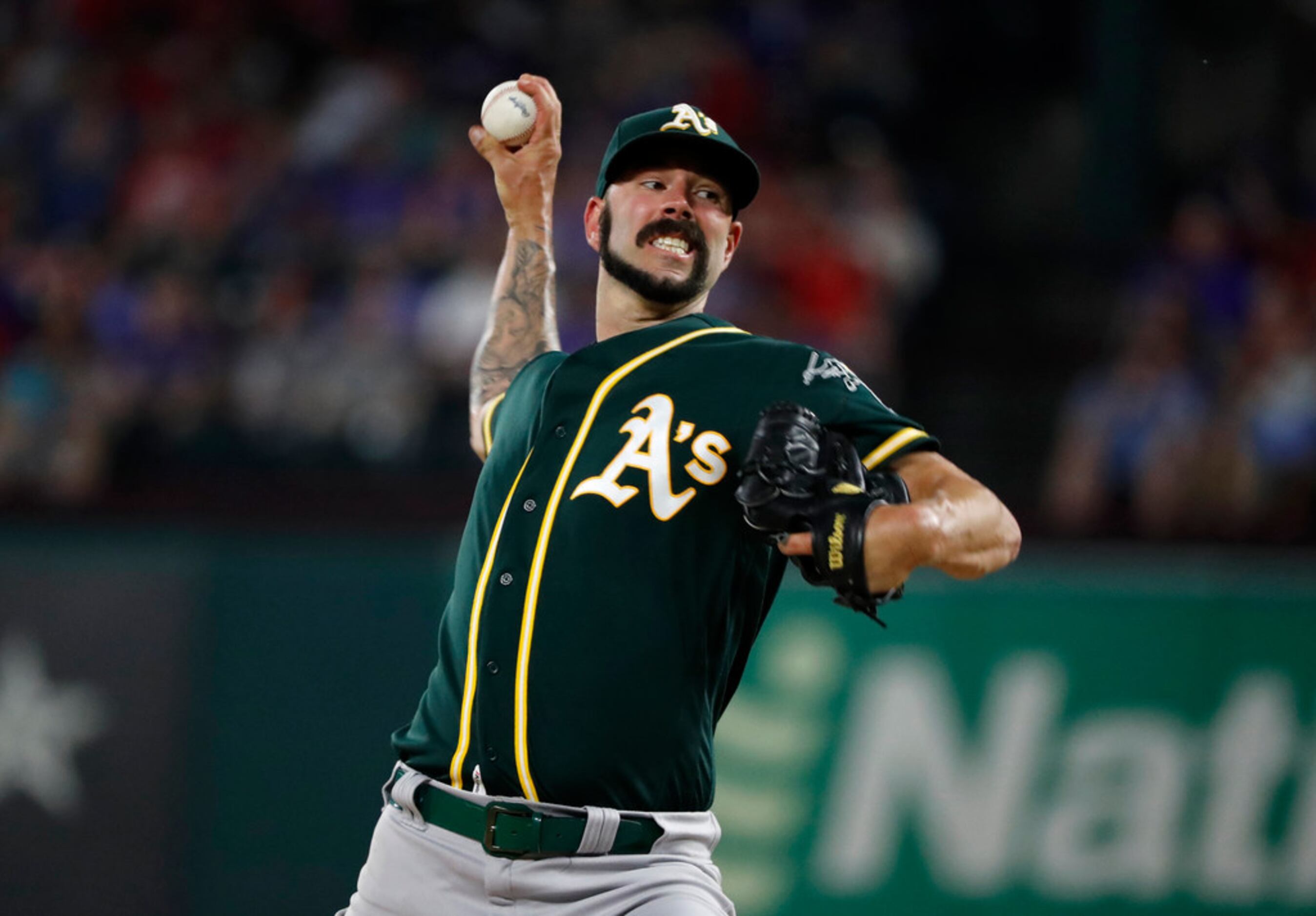 Oakland Athletics starting pitcher Mike Fiers throws to the Texas Rangers in the second...