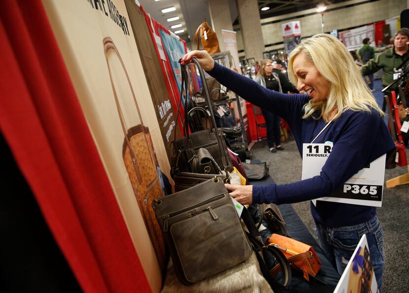 Rebecca Schneider looks at a concealed carry handbag at the NRA Annual Meeting & Exhibits at...