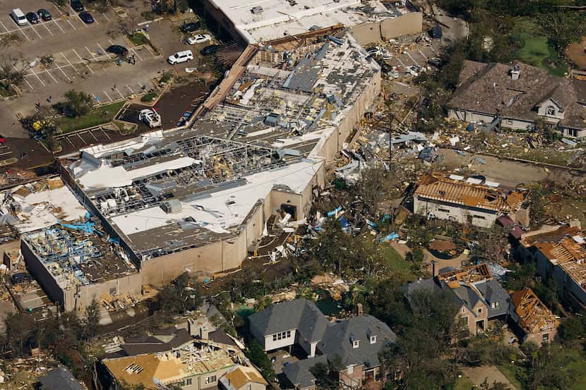 Damage is seen to the Preston Royal shopping center and neighboring homes in an aerial view...