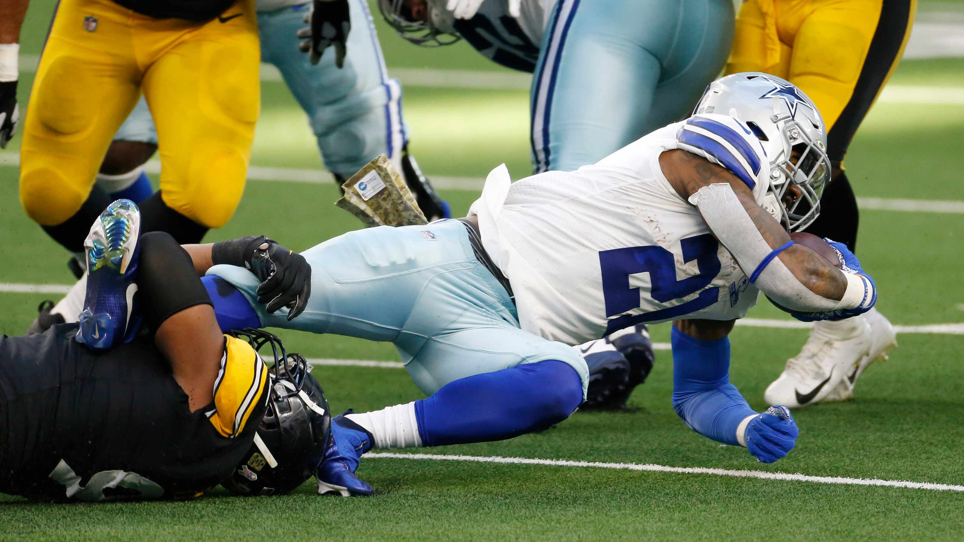 Dallas Cowboys running back Ezekiel Elliott (21) is stopped by Pittsburgh Steelers defensive...
