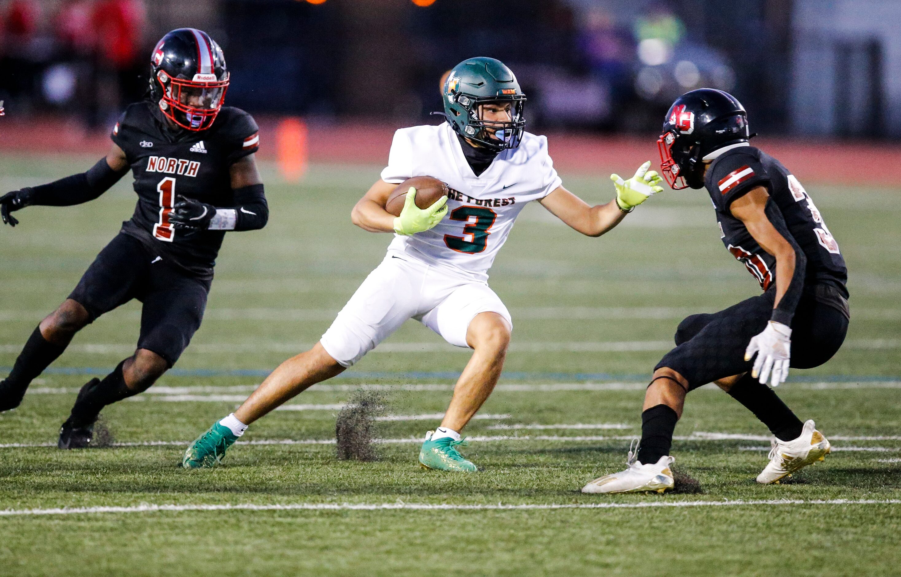 Garland Naaman Forest senior wide receiver Mike Deluna (3) looks for room against North...