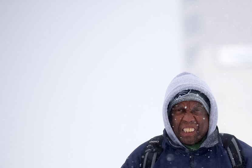 ATLANTIC CITY, NJ:  A man reacts to the wind and snow while walking on January 4, 2018 in...