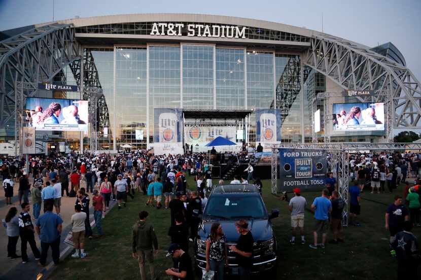 Fans gathered outside AT&T Stadium to watch the NFL draft during the Cowboys draft party in...
