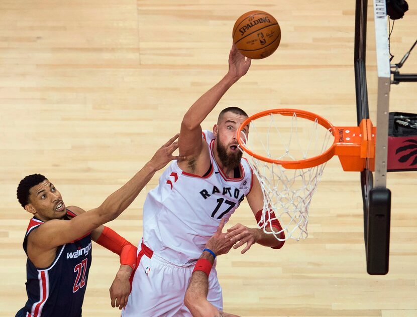 Toronto Raptors center Jonas Valanciunas (17) scores past Washington Wizards forward Otto...