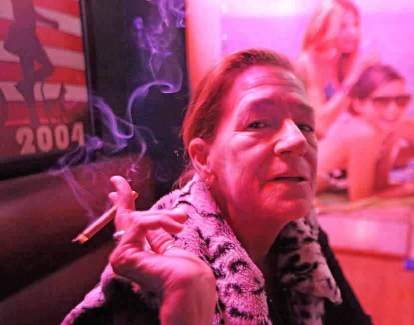 Dianna Gohl enjoys a cigarette at Ebeneezer's Pub and  Grill on Northwest Highway in...