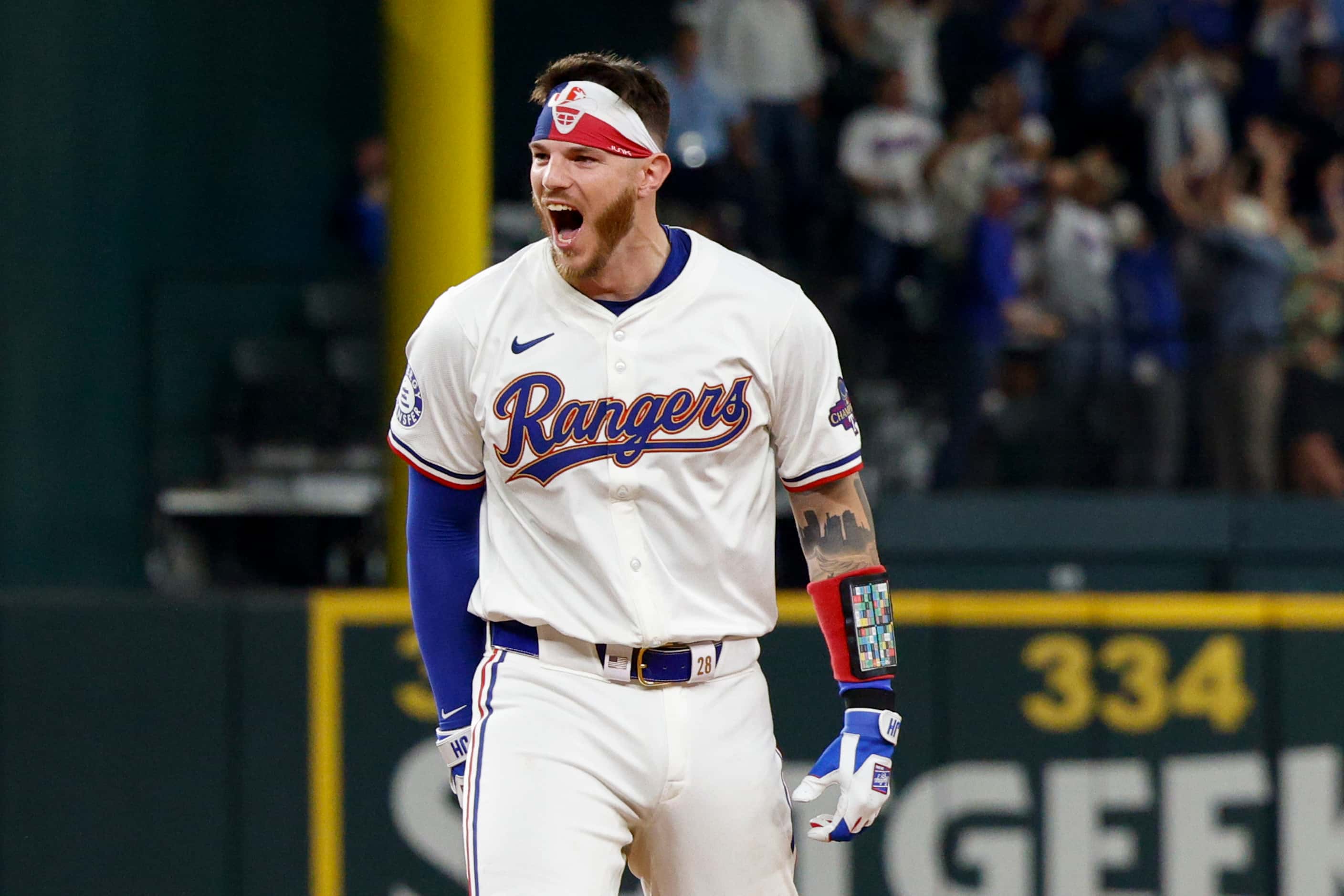 Texas Rangers catcher Jonah Heim (28) reacts after the game-winning hit in the 10th inning...