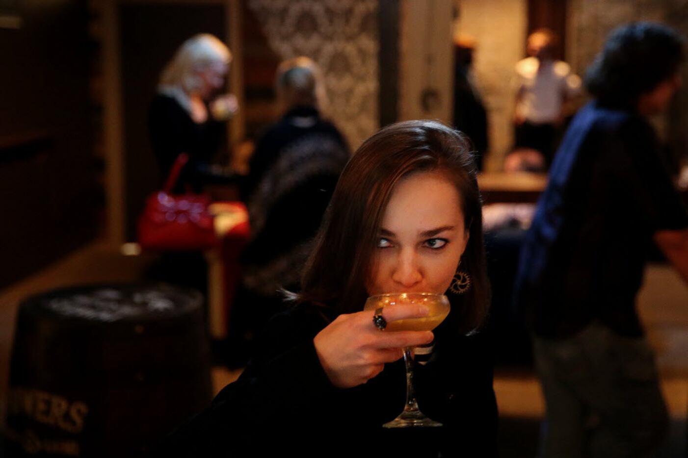 Dasha Kiseleva tries a mixed drink inside High & Tight.
